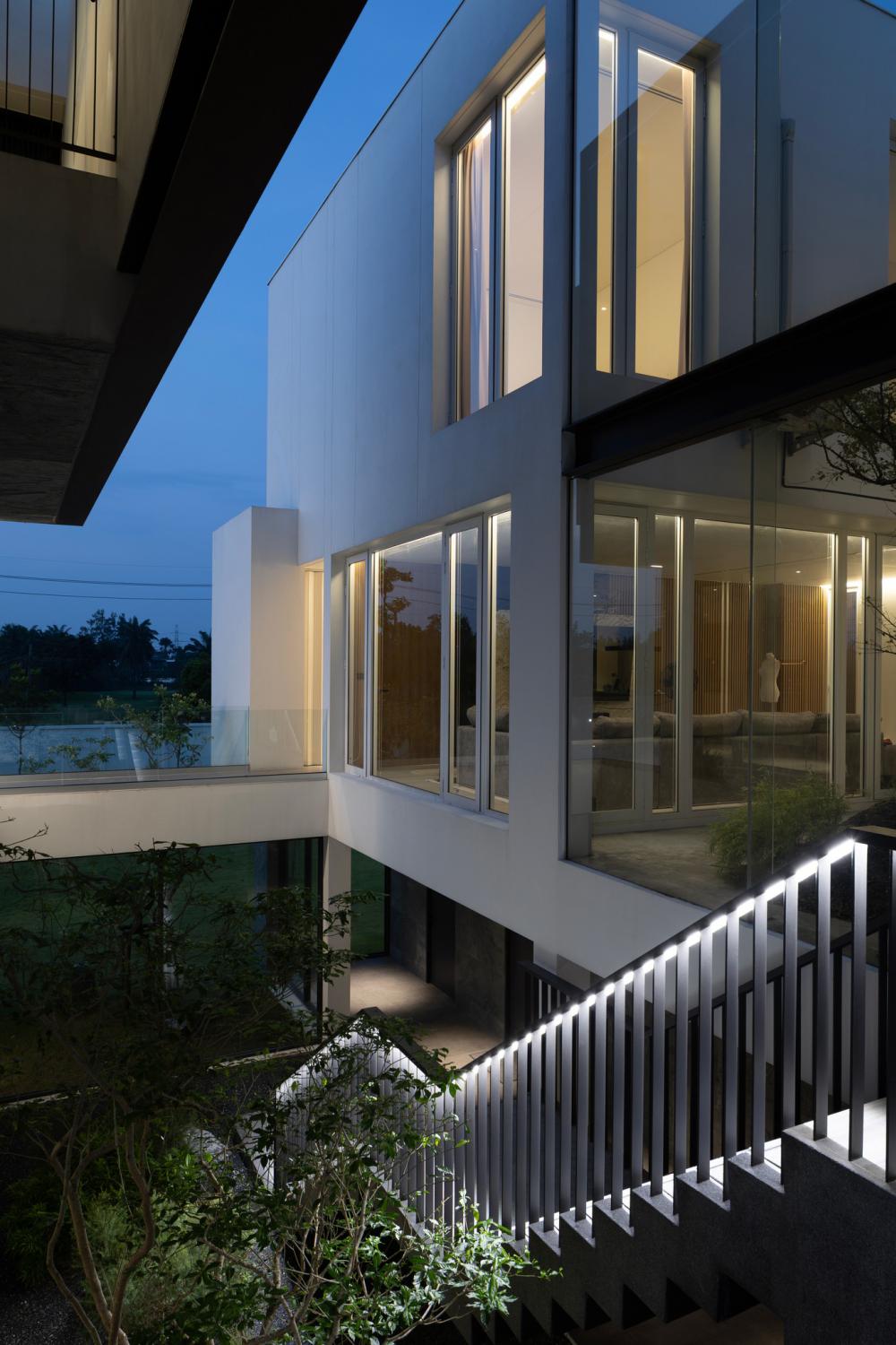 บ้านโมเดิร์นทรงกล่องบ้านหลังนี้ตั้งอยู่บนที่ดินในโครงการสนามกอล์ฟซึ่งมีพื้นที่สีเขียวขนาดใหญ่รายล้อมและด้านหลังของที่ดินยังติดกับพื้นที่แฟร์เวย์ของสนามกอล์ฟ รูปที่ 10