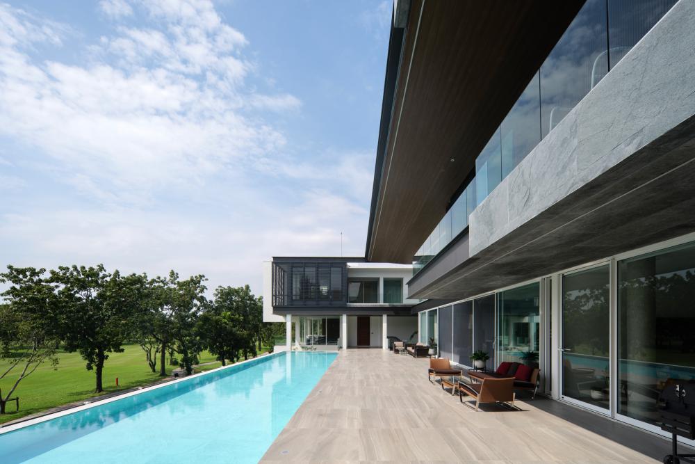 บ้านโมเดิร์นทรงกล่องบ้านหลังนี้ตั้งอยู่บนที่ดินในโครงการสนามกอล์ฟซึ่งมีพื้นที่สีเขียวขนาดใหญ่รายล้อมและด้านหลังของที่ดินยังติดกับพื้นที่แฟร์เวย์ของสนามกอล์ฟ รูปที่ 3